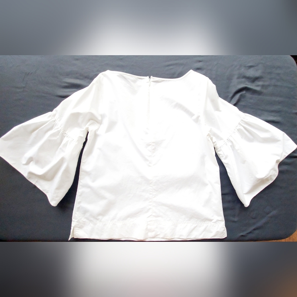 A white poplin blouse by Ralph Lauren with striking bell sleeves.
